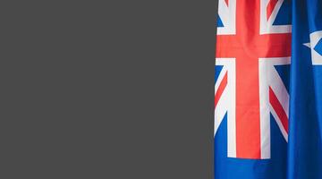 Close-up of the Australian flag is on the right side on a gray background photo