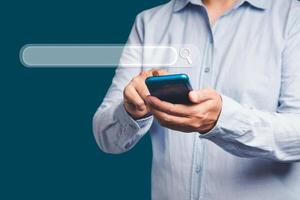 Close-up of hand a man using a smartphone for search information on a web browser photo