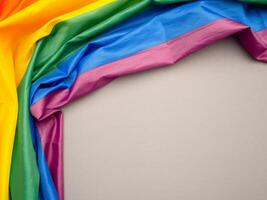 Top view of the rainbow flag or LGBT is on a gray background with copy space photo