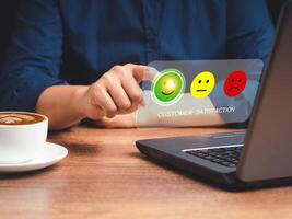 Positive feedback concept. Choosing a green happy mood icon rating review in the survey, poll, or customer satisfaction research on a virtual screen photo