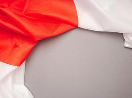 Top view of the Japan flag on a gray background with space for text photo