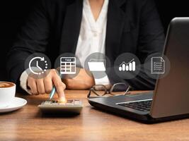 Tax day concept. Man using a calculator to calculate tax while sitting in the office photo