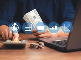 Tax day concept. Man using a calculator to calculate tax while sitting in the office photo