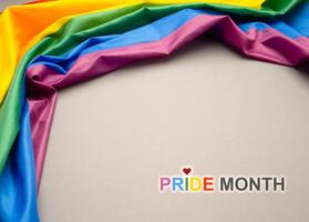 Pride month. Top view of the rainbow flag or LGBT is on a gray background with copy space photo