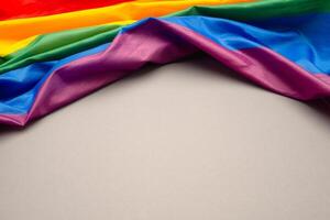 Top view of the rainbow flag or LGBT is on a gray background with copy space photo