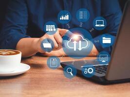 Businessman using a laptop login to the cloud computing while sitting in the office photo