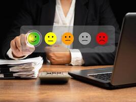 Positive feedback concept. Choosing a green happy mood icon rating review in the survey, poll, or customer satisfaction research on a virtual screen photo
