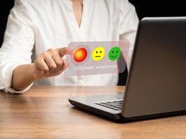 Negative feedback concept. Choosing a red sad mood icon rating review in the survey photo