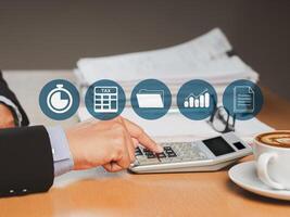 Tax day concept. Close-up of the hand using a calculator to calculate taxes while sitting in the office photo
