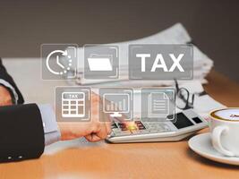 Tax day concept. A businessman uses a calculator to calculate taxes while sitting in the office photo