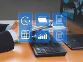 A businessman uses a calculator to calculate taxes while sitting in the office photo