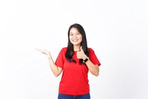 Presenting and Showing Product on Open Palm With Thumbs up Of Beautiful Asian Woman wearing red shirt Isolated On White Background photo
