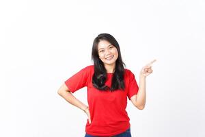 Presenting and Pointing Right side of copyspace using forefinger for advertising Of Beautiful Asian Woman wearing red shirt Isolated On White Background photo