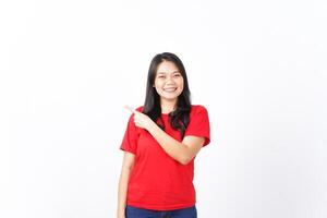 Smiling, Presenting and Pointing aside for showing product for advertising Of Beautiful Asian Woman Wearing red shirt Isolated On White Background photo