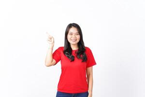 Smiling, Presenting and Pointing aside for showing product for advertising Of Beautiful Asian Woman Wearing red shirt Isolated On White Background photo