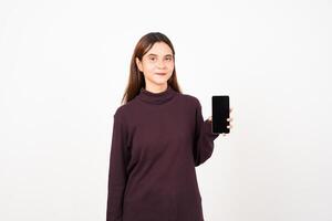 Smiling presenting and holding blank screen smartphone Of Beautiful Asian Woman Isolated On White Background photo