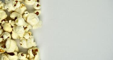 Group of pop corn snacks isolated on horizontal copy spaced plain background. photo