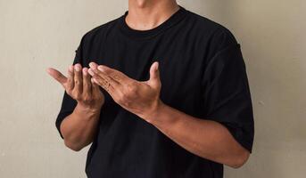 Young man showing an individual showing sing language photo