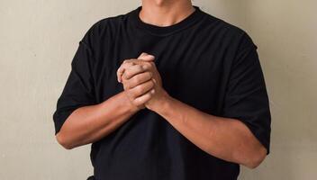 Young man saying believe in sign language, showing asl lesson, communication photo