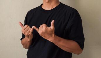 Young man hand gesture about stop sign language to teaching or assist colleagues photo