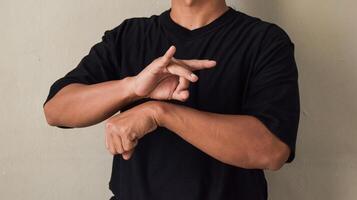 Young man showing happiness using sign language photo