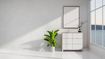 A minimalist white living room features a minimal wooden drawer by the window with a lake view. photo