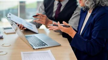 A close-up hands image, Two business people are in the meeting, looking at a laptop while discussing photo