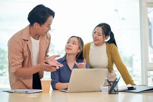 A team of smart young employees focused on discussing work, sharing helpful ideas in a modern office photo