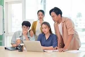 A group of young business startup team focused on discussing and brainstorming in the office. photo