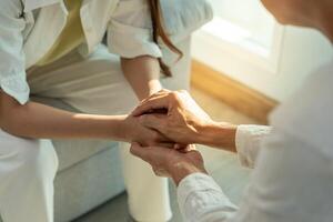 psychiatrist hold hand support each while discussing family issues. doctor encourages and empathy woman suffers depression. psychological, save divorce, Hand in hand together, trust, care photo