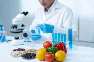 Scientist check chemical food residues in laboratory. Control experts inspect quality of fruits, vegetables. lab, hazards, ROHs, find prohibited substances, contaminate, Microscope, Microbiologist photo