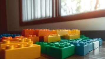 un pila de legos en un mesa en frente de un ventana foto