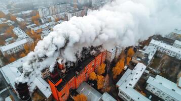 An aerial view of a factory with smoke coming out of it photo