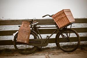 old bicycle with can and basket photo
