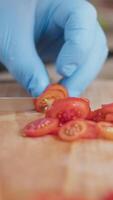 Chef Cuts Red Cherry Tomatoes On A Wooden Cutting Board video