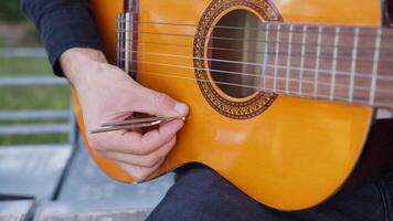 Man Tunes Guitar With Tuning Fork For Notes video