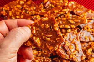 Homemade sugar cookies with nuts in a man's hand with a blurred background photo