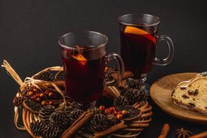Festive Christmas mulled wine with stollen on a black background photo