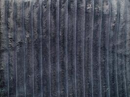 Soft dark gray textured fabric with vertical patterns. Concept of luxury material, interior design, textile backgrounds. Texture photo