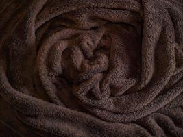 Luxurious Cozy Brown Fleece Blanket with Soft Texture and Warm Comfort for Relaxation at Home. Background, Texture photo