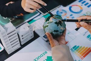 Carbon offset price report CO2 emission. Future growth Net zero waste in ESG ethical SME office protect climate change global warming social issues project. Group of asia people Eco friendly SDGs plan photo