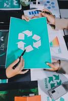 Carbon offset price report CO2 emission. Future growth Net zero waste in ESG ethical SME office protect climate change global warming social issues project. Group of asia people Eco friendly SDGs plan photo