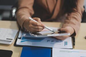 business documents businessman check legal document review Prepare documents or analysis reports, tax items, accounting documents, data contracts, office partner agreements. photo