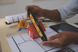 Image of engineer meeting for architectural project. working with partner and engineering tools on workplace vintage tone. photo