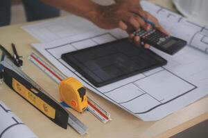 Image of engineer meeting for architectural project. working with partner and engineering tools on workplace vintage tone. photo