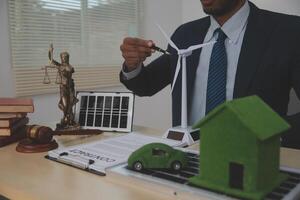 Auctioneer knocks down property sale by sample house and lawyer's gavel, judge mediates in property dispute in court car judge's gavel on wooden background Buying and selling real estate, housing photo