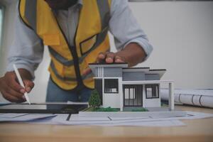 Image of engineer meeting for architectural project. working with partner and engineering tools on workplace vintage tone. photo