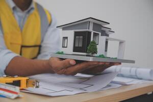 Architects, engineers, contractors working in the office with blueprints, inspection engineers Work analysis for architectural plan, construction project sketch, focus, business construction concept. photo
