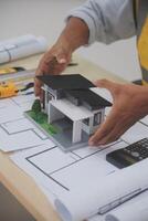 Architects, engineers, contractors working in the office with blueprints, inspection engineers Work analysis for architectural plan, construction project sketch, focus, business construction concept. photo