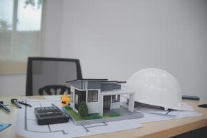 Architects, engineers, contractors working in the office with blueprints, inspection engineers Work analysis for architectural plan, construction project sketch, focus, business construction concept. photo